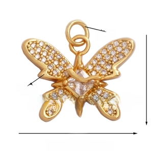 Detailed view of a gold butterfly pendant with white zircon inlay and 21mm width measurement