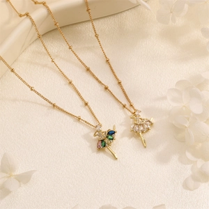 Elegant gold ballerina pendant necklace with colorful zircon stones on silk background