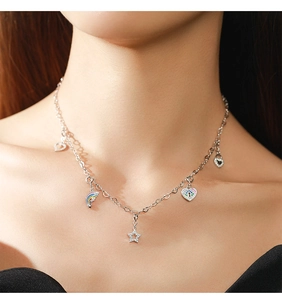 Detail of S925 silver necklace featuring heart, rainbow, and star charms with crystals