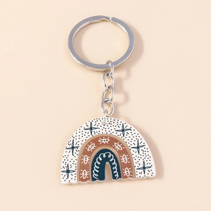 Rainbow acrylic keychain with eyes and stars in earth tones on a beige background