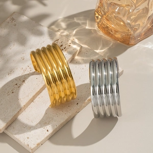 Minimalist wide ribbed open bangle bracelet in polished gold and silver finish