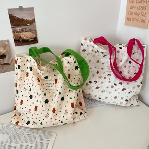 Detail showing wavy textured fabric and cute cartoon bear print on canvas tote bags