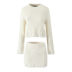Cream knit set featuring a long sleeve cable knit sweater and matching mini skirt