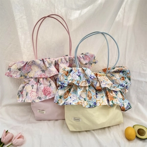 Dettaglio di borse tote floreali con volant in rosa e giallo dallo stile bucolico