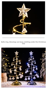 Detail of metal spiral Christmas tree with crystal pendants and glowing LED star topper
