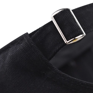 Close-up of adjustable silver metal buckle on black washed cotton baseball cap texture