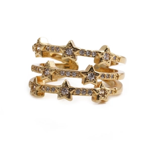Detail of three-layer gold star ring with cubic zirconia stones on white background