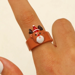 Close-up of a cute cartoon reindeer ring with red Christmas hat detail on a hand