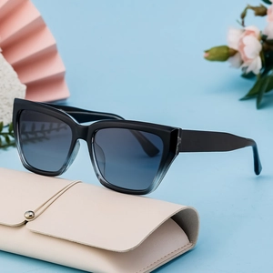 Fashion cat eye sunglasses with black gradient frames and a beige leather storage case
