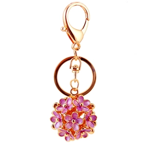 Golden keychain with a 3D purple flower ball pendant featuring intricate floral cutouts