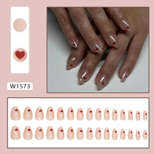 Pink gradient press-on nails with red heart patterns in a 24-piece professional set