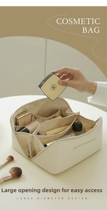 Detail of cream cosmetic bag with large opening and organized inner compartments