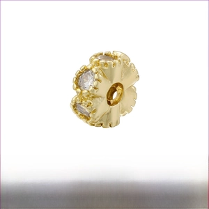 Detailed view of 14K gold plated honeycomb brass spacer bead with cubic zirconia stones