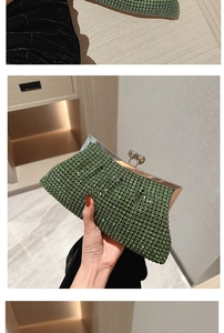 Close-up of luxury green rhinestone clutch bag featuring a silver metal clasp