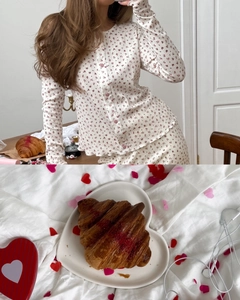 Detail of floral knit loungewear set with red pattern and elegant button cardigan