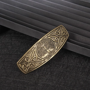 Detailed macro view of vintage bronze Tree of Life hair clip with Celtic knot patterns