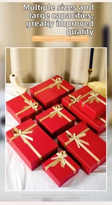 Set of multi-size red gift boxes with golden satin ribbons for weddings and festivals