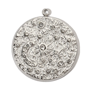 Macro shot of silver Tree of Life pendant with celestial sun and moon crystal inlay