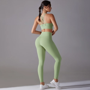 Side view of light green high-waisted yoga leggings and cross-back sports bra set