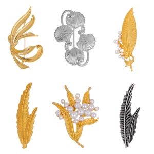 Assorted vintage matte gold and silver brooches featuring wheat ears and feathers