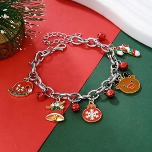 Detailed shot of Christmas charm bracelet with snowflake, bell, and reindeer pendants