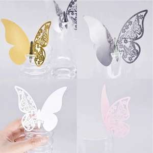 Detail of laser-cut butterfly place cards in gold, silver, white and pink colors