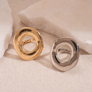 Minimalist hollow irregular oval rings in gold and silver finish on white stone