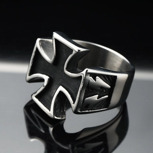 Macro shot of steel gothic ring featuring a black iron cross and lightning bolt engraving