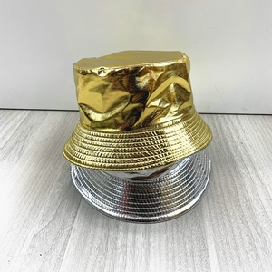 Close-up of metallic faux leather bucket hats in shiny gold and silver finishes