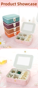 Detailed view of mini suede jewelry box interior with mirror and multi-color storage slots