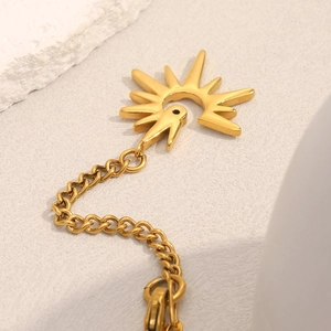 Macro shot of 18K gold plated stainless steel star pendant with refined tassel chain