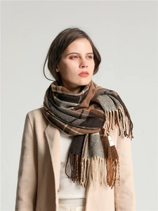 Detailed view of soft thick brown plaid scarf featuring classic fringe edges for winter