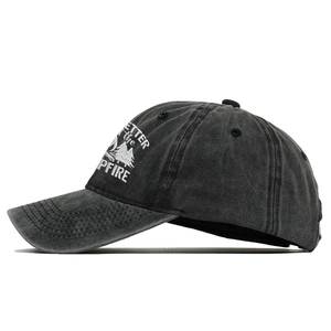 Detail of embroidered mountain and campfire text on washed cotton baseball cap