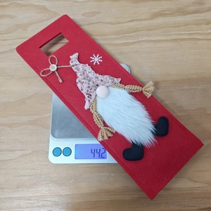 Gnome Christmas wine bottle cover with sequins on scale showing 44.2g weight