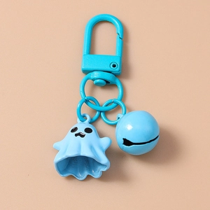 Close-up of a blue cartoon ghost keychain with matching bell and metal clasp
