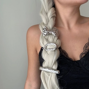 Three-piece silver hair clips set with hammered texture worn on blonde braided hair