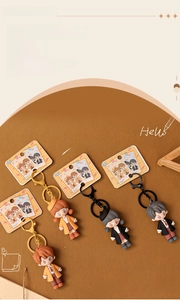 Detail of four cute soft rubber cartoon couple keychains with colorful metal clips