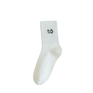 White cotton crew socks for women featuring minimalist black face embroidery on white fabric