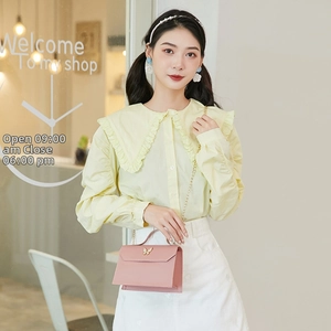 Pink crossbody bag featuring a golden butterfly clasp and elegant metal chain strap