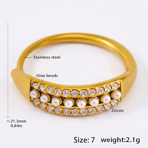Detail view of gold stainless steel ring with zircon accents and pearl beads inlay