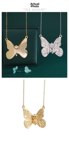 Detailed macro view of butterfly pendant showing 3D relief texture in gold and silver