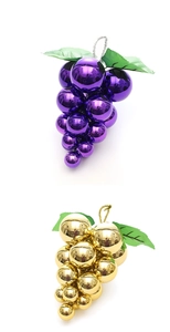 Macro detail of glossy purple and gold grape-shaped Christmas ball ornaments with leaves