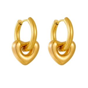 Close-up of gold heart drop earrings featuring polished stainless steel hoops and charms