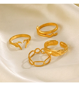 Set of four 18K gold plated stainless steel geometric rings on cream silk fabric