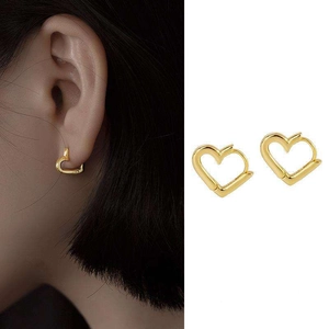 Detail view of heart-shaped gold hoop earrings with split view showing on-ear style