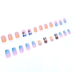 Press-on nail set with tropical gradient design and black coconut tree silhouettes