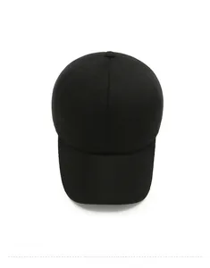 Top view of black wool baseball cap with silver metal side logo and textured fabric