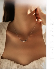 Close-up of S925 silver necklace with curved colorful gemstone pendant on model's neck