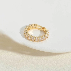 Detail showing gold eternity ring with oval claw-set cubic zirconia and adjustable opening