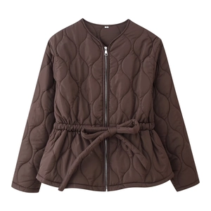 Détail d'une veste matelassée marron avec fermeture éclair et ceinture à la taille